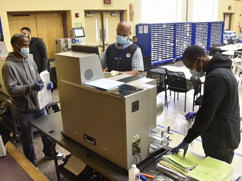 From left: Prince George’s County election workers Darnell Eastman, Mark Mosby and Chancelor Richardson count and prepare to load ballots in the vote tabulator at Lake Arbor Elementary School in Mitchellville, Maryland, on July 29, the last day to canvass provisional and mail-in ballots. (Robert R. Roberts/The Washington Informer)