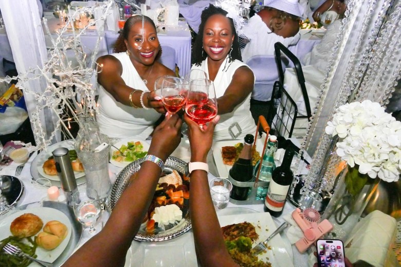 Guests toast at Le Diner En Blanc-Washington on Sept. 21. (Shevry Lassiter/The Washington Informer)