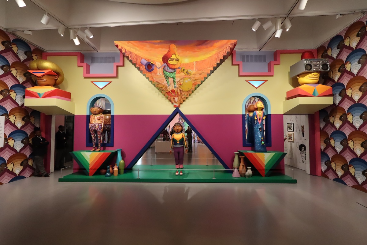 A vibrant installation by OSGEMEOS, featuring their signature yellow characters integrated into a colorful and surreal architectural environment. The installation immerses viewers in a dreamlike world, merging sculpture with mural work. (Andrew Jacobson/The Washington Informer)