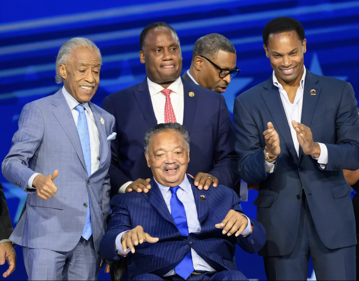 The Rev. Jesse Jackson (front center) was flanked by the Rev. Al Sharpton, his son U.S. Rep Jonathan Jackson and his son Yusef Jackson during the Democratic National Convention on Aug. 20. (Earl Gibson/The Washington Informer)