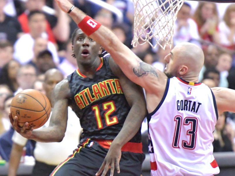 Atlanta Hawks forward Taurean Prince (12) attempts a shot around Washington Wizards center Marcin Gortat in the first quarter of the Wizards' 114-107 win in Game 1 of the Eastern Conference first-round playoff series at Verizon Center in D.C. on April 16. (John De Freitas/The Washington Informer)