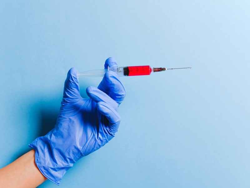person holding syringe