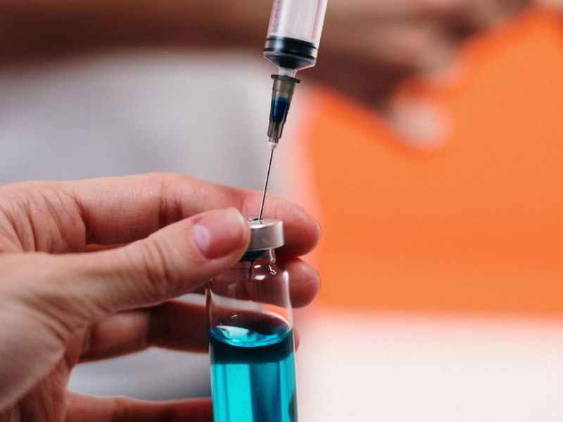 person holding a vaccine