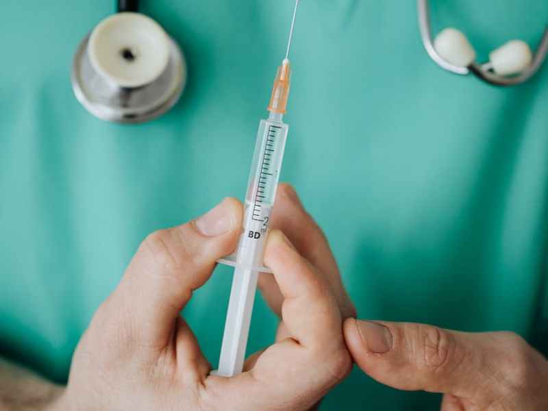 person holding a vaccine