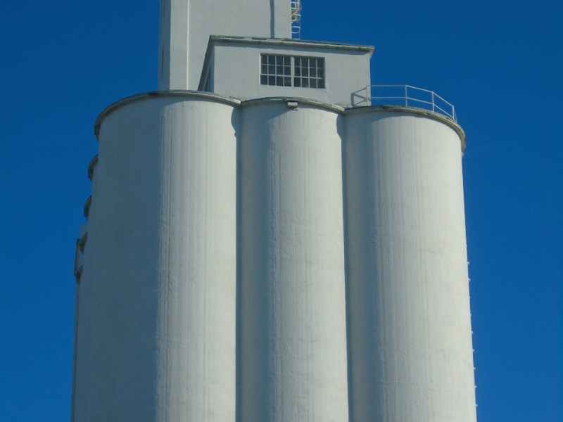 a grain elevator under a clear blue sky