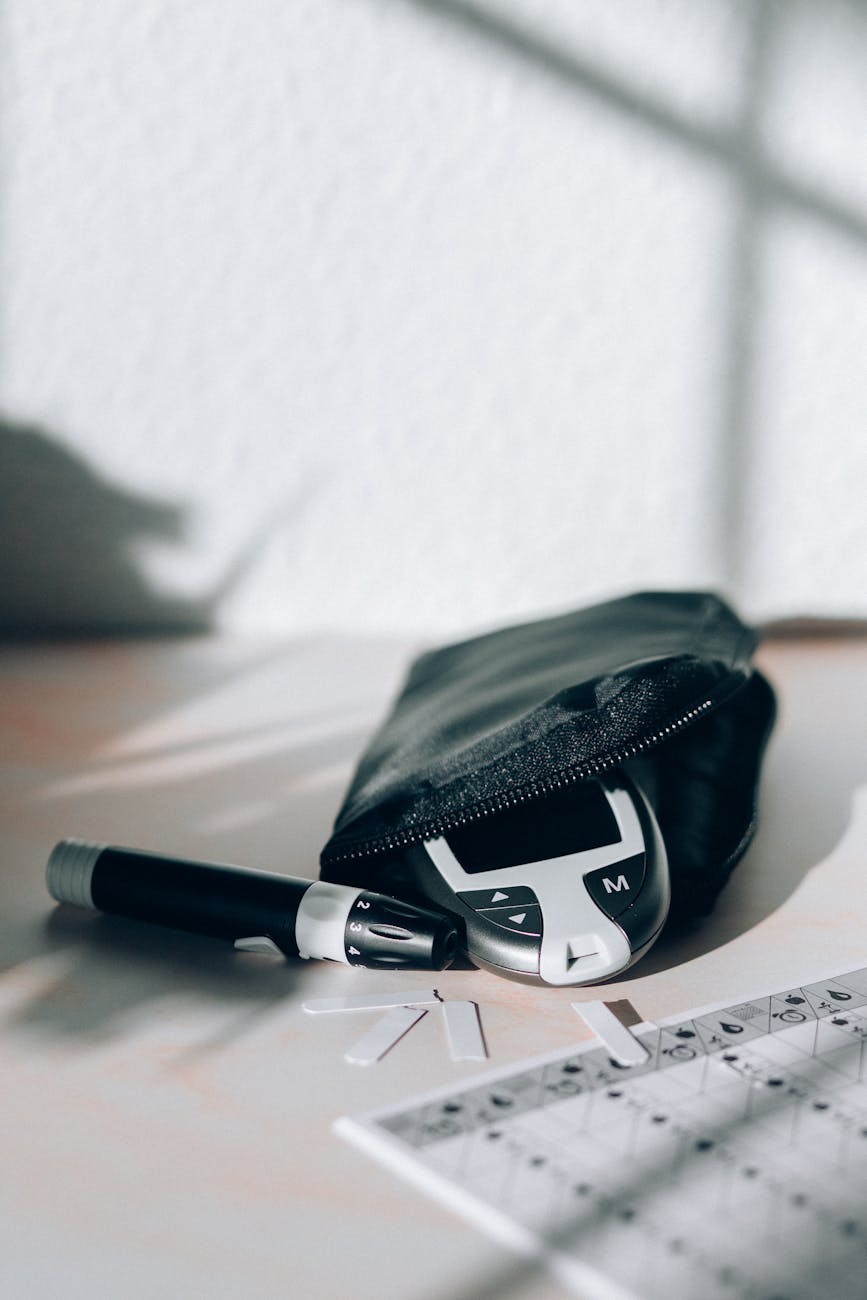 black and white click pen beside black leather pouch