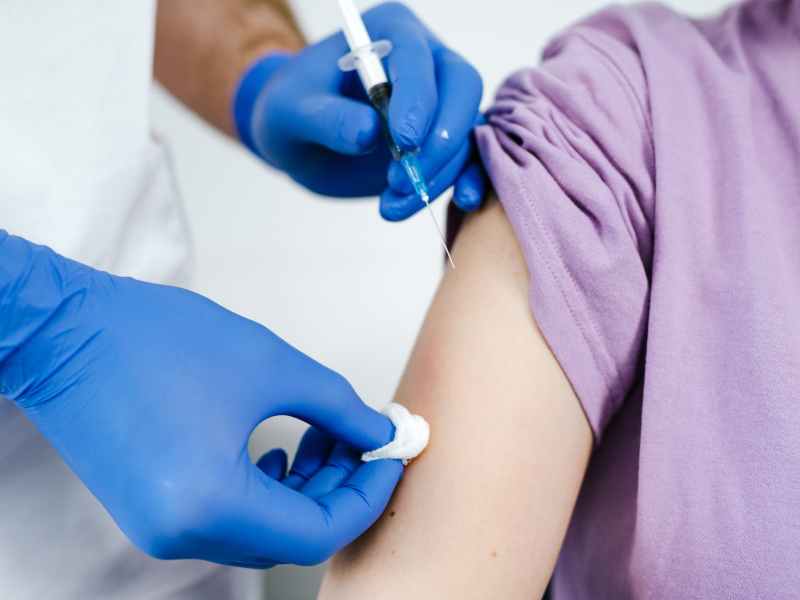 close up shot of a health worker injecting a vaccine on a patient