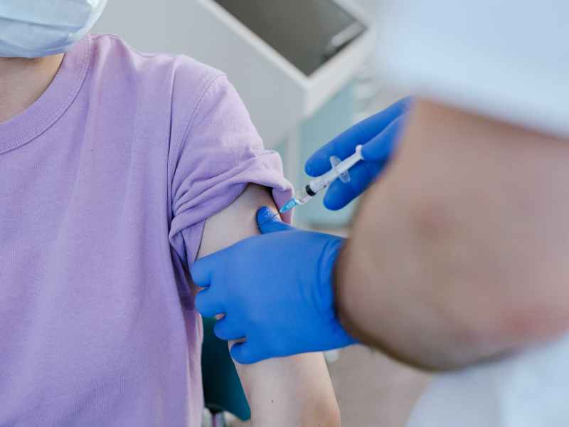 close up shot of a health worker injecting a vaccine on a patient